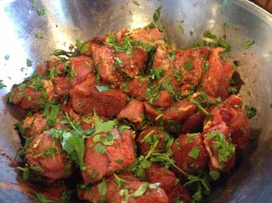 Marinate cilantro, cumin, paprika covered pork for two hours.